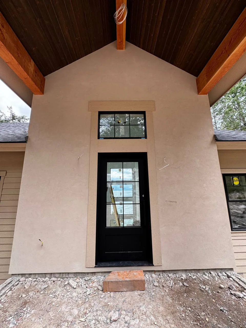 Real-world example of a light beige stucco color finish applied to a home exterior by DL Construction