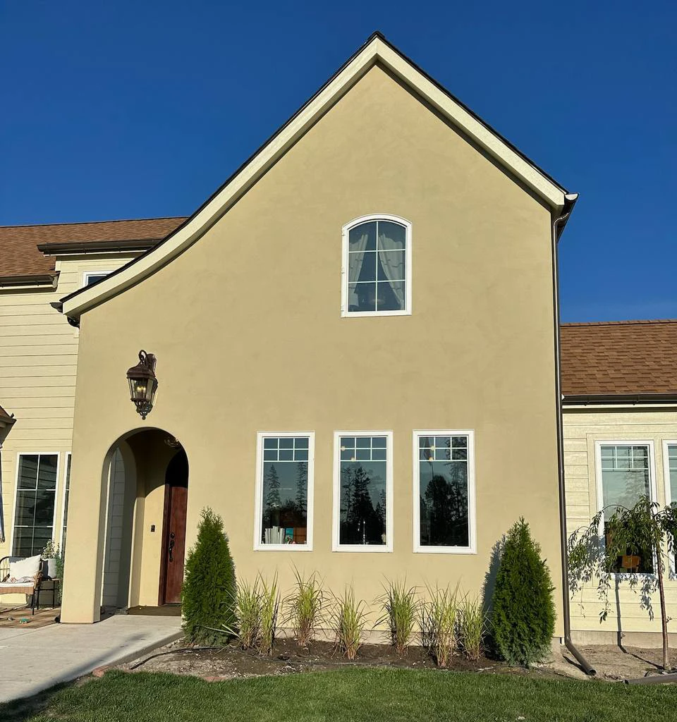 Fine beige stucco finish on a residential home exterior providing a seamless barrier