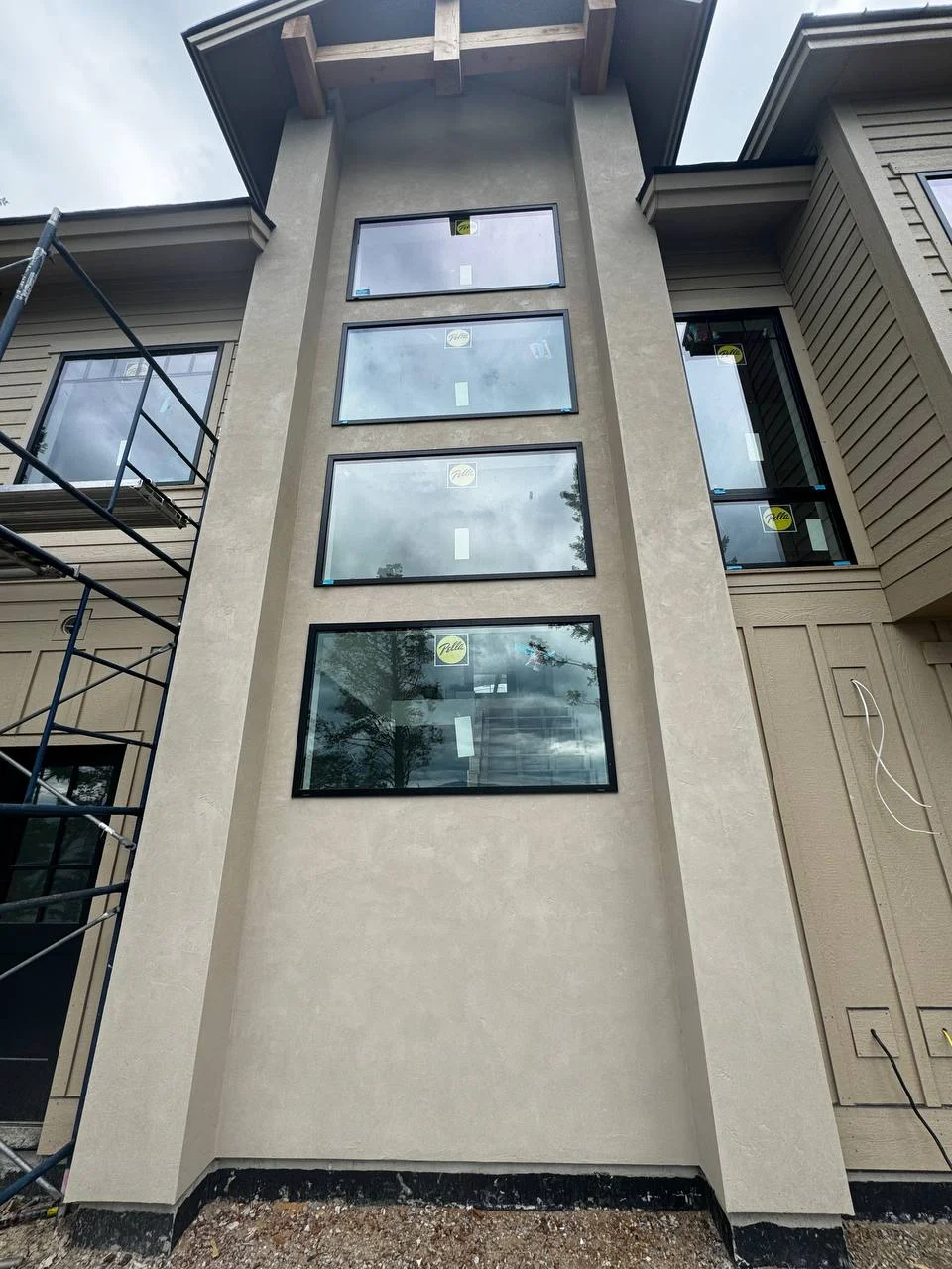 Smooth taupe stucco finish seamlessly integrating with modern siding and natural wood accents